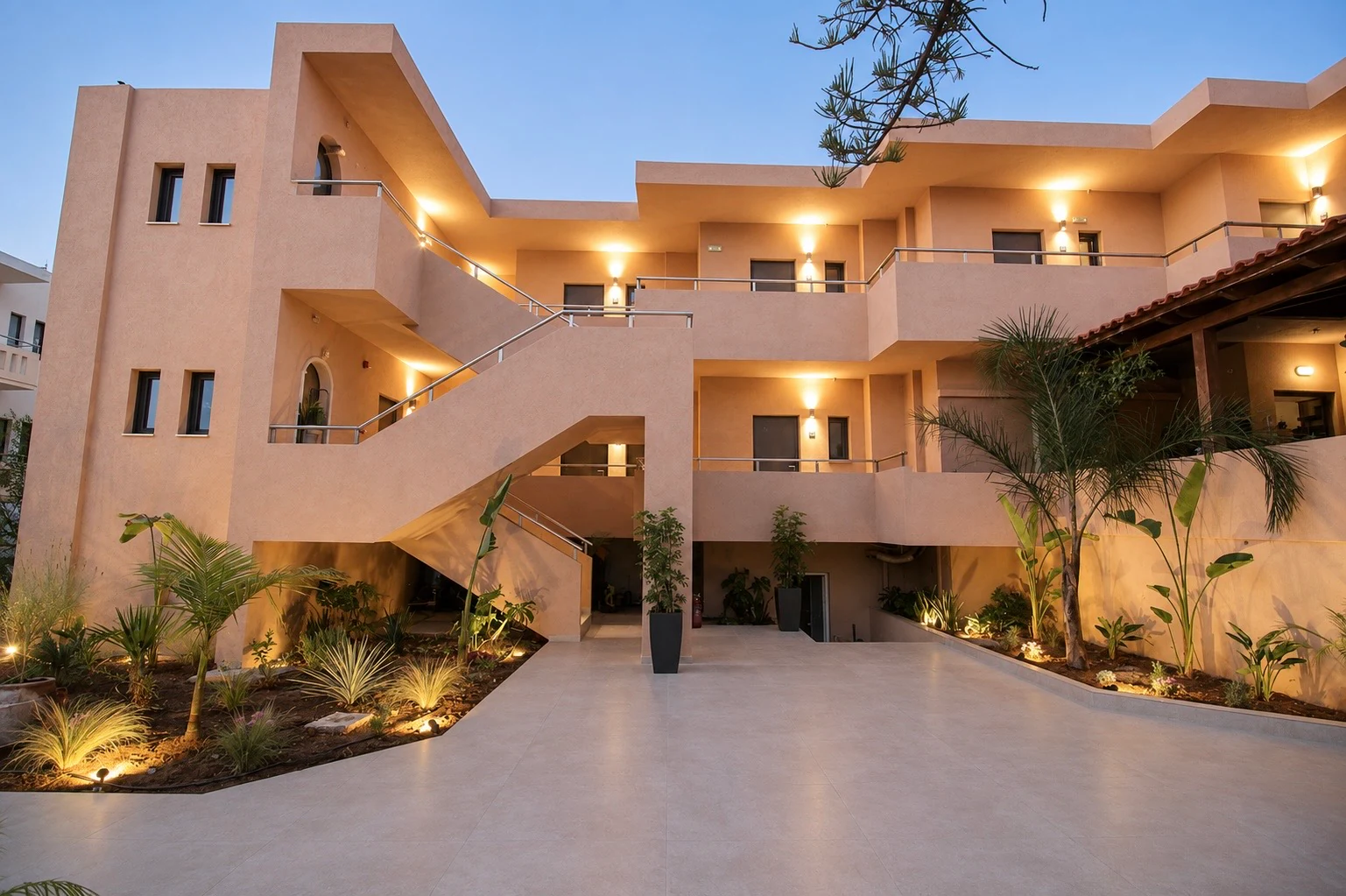 Eos Mare courtyard at dusk with warm lighting