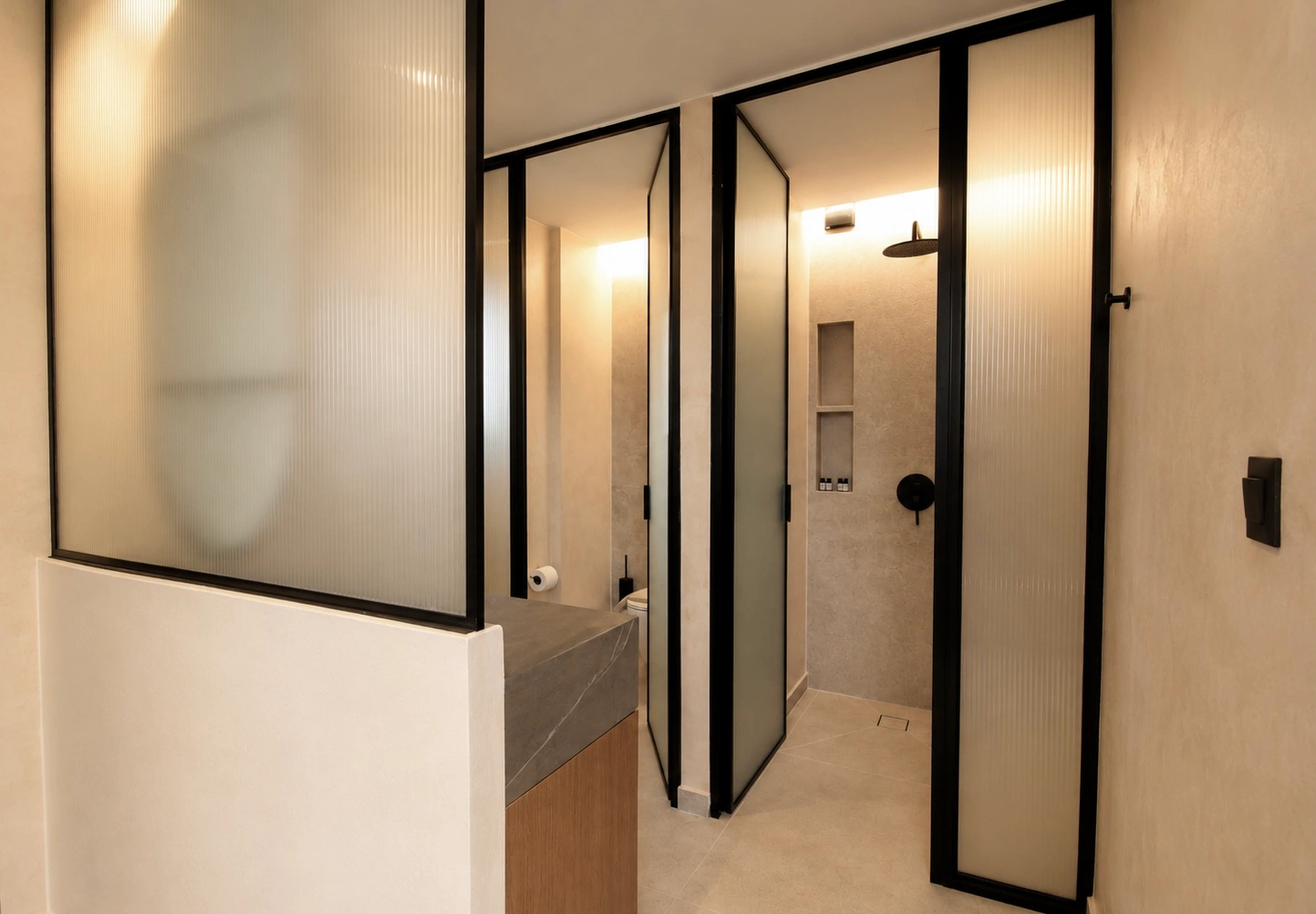 Deluxe Studio bathroom with walk-in shower and glass partitions at Eos Mare
